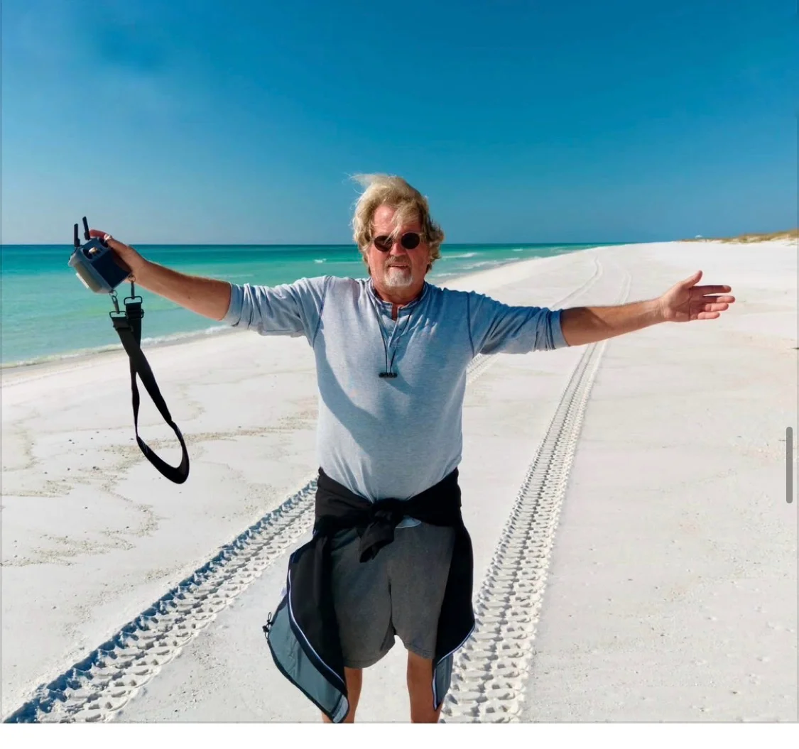 Ed Gutentag, Kova Mobility driver &mdash; beach shot with drone controller, Gulf of Mexico backdrop